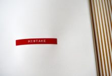 A red sticker with a word “mistake” written on it