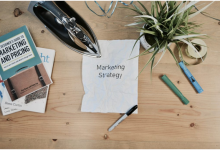 Paper that says marketing strategy on a table