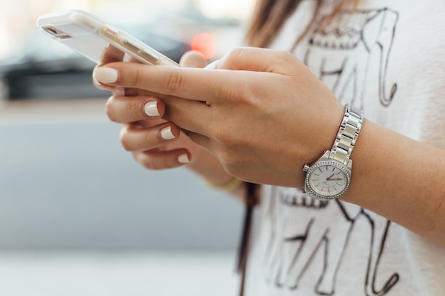 A woman holding a phone in her hands.